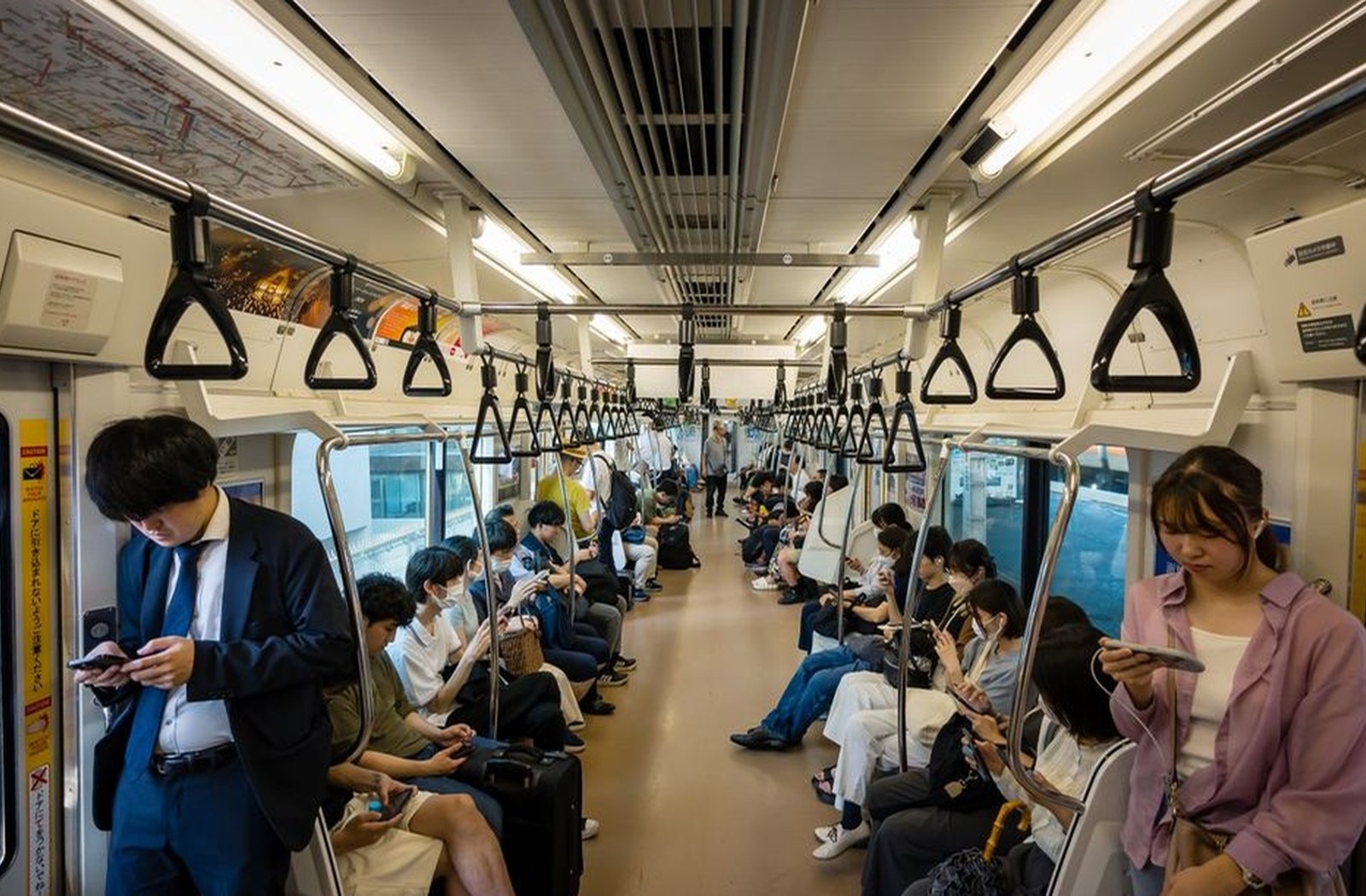 Passengers riding public transit through the city on an ordinary day.